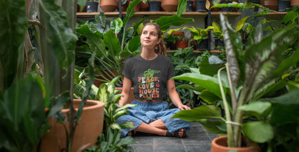 A woman sitting in a room full of plants
